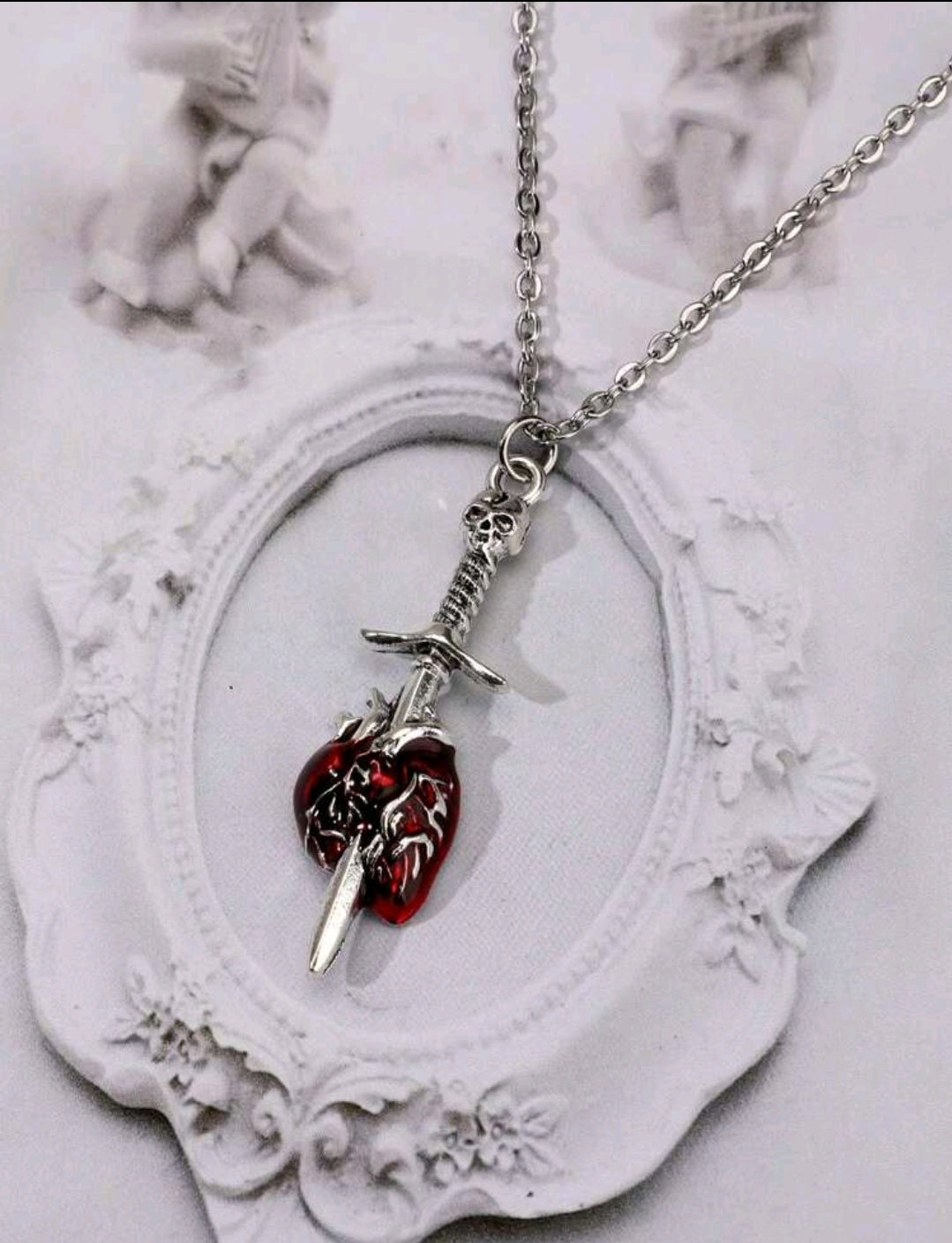 Necklace of a heart pierced by a sword